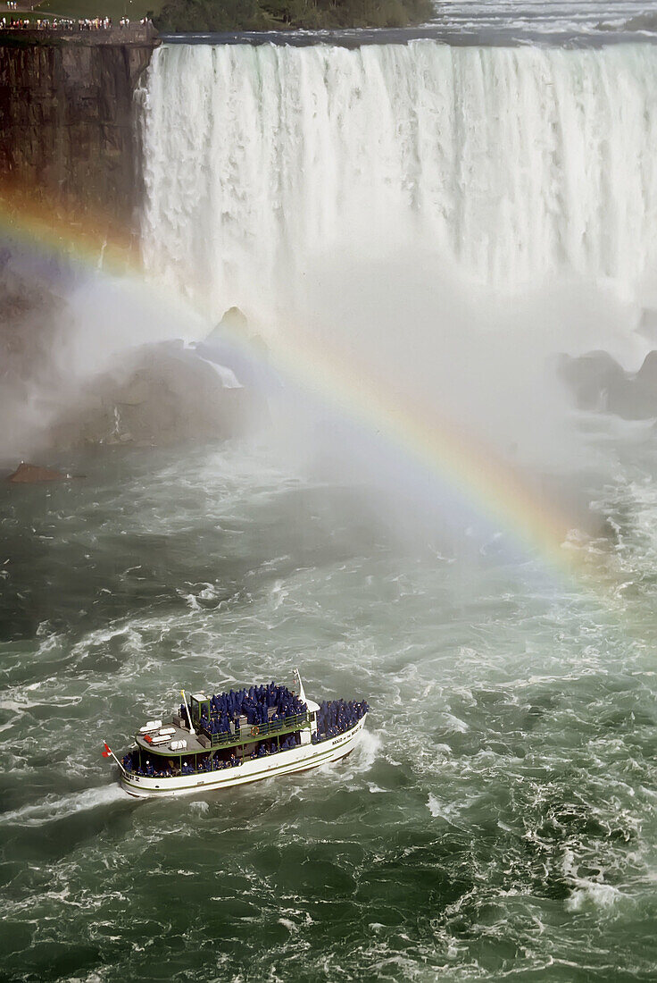 Maid of the Mist tourist boat and rainbow at Niagra Falls Ontario Canada and the United States