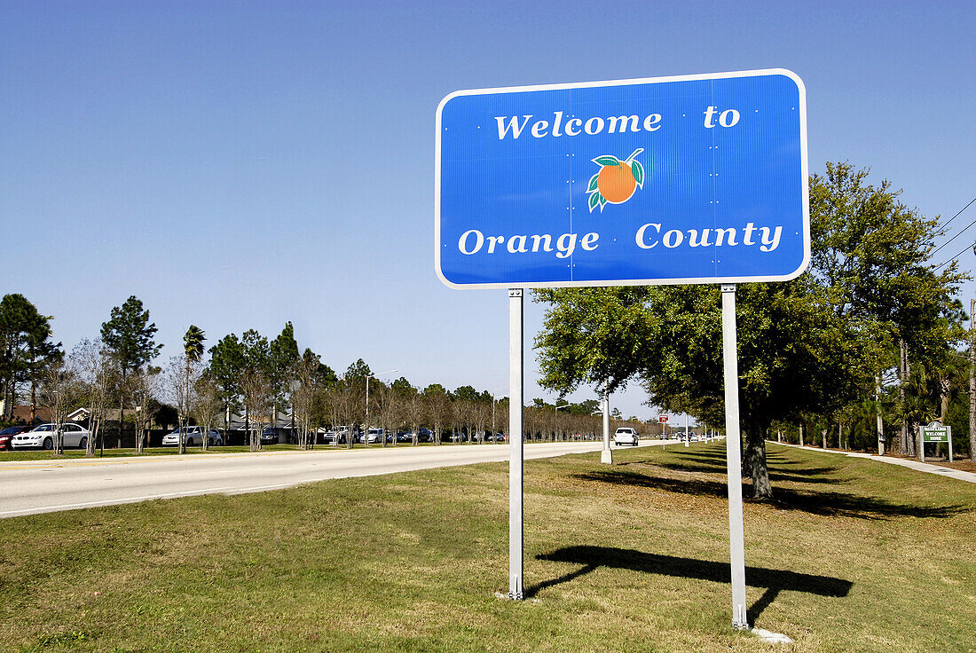 County road sign Welcoming Drivers to Orange County Kissimmee Orlando Disney Theme Park Area. Florida. USA