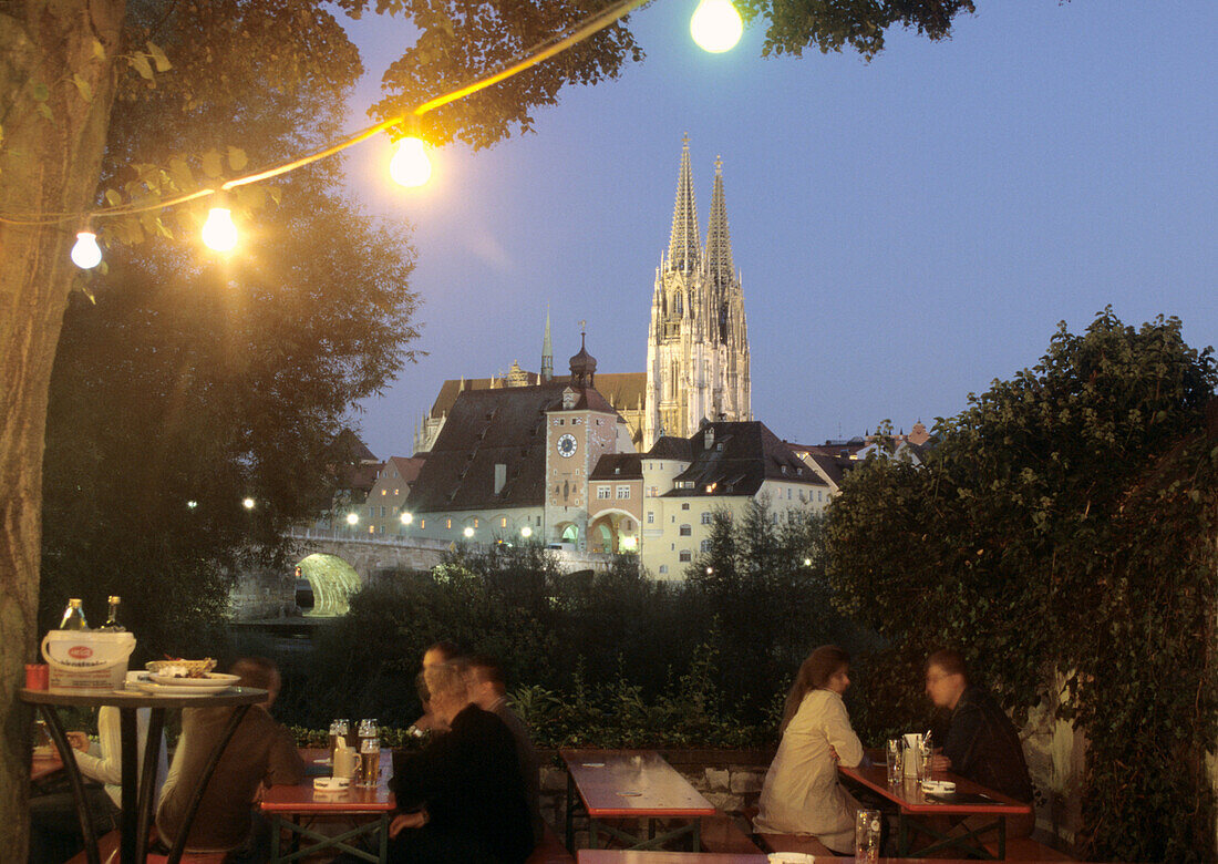 Old Linde beer garden in the evening, view to Regensburg Cathedral, Upper Palatinate, Bavaria, Germany