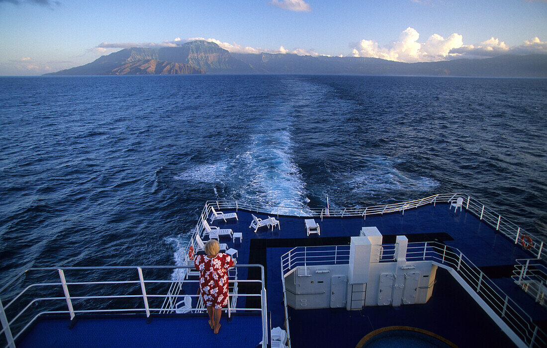 The ship Aranui III on its way, with the island of Hiva Oa in the background, French Polynesia
