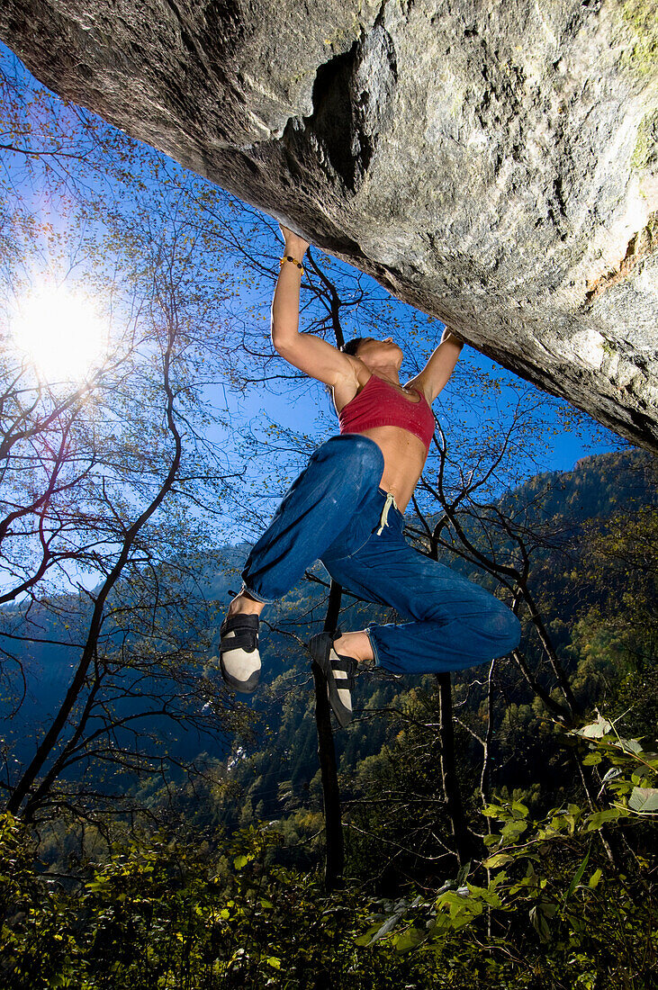 Female free climber bouldering, Malta Valley, Hohe Tauern National Park, Carinthia, Austria