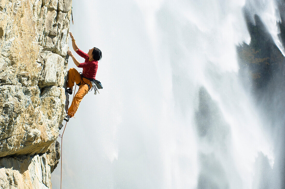 Woman, Barbara Raudner, rock climbing in Maltatal, Waterfall in the background, Maltatal, Hohe Tauern National Park, Carinthia, Austria