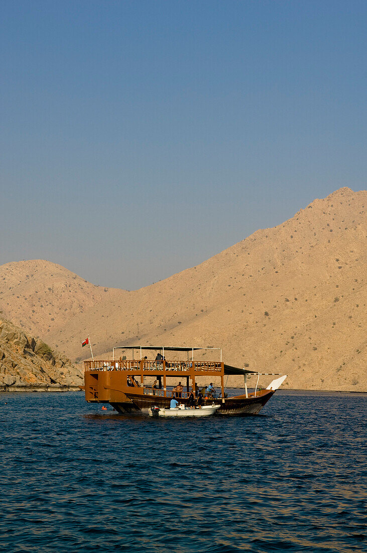 Boat with tourists, Dhow, in the Haijar Mountains, Musandam, Oman