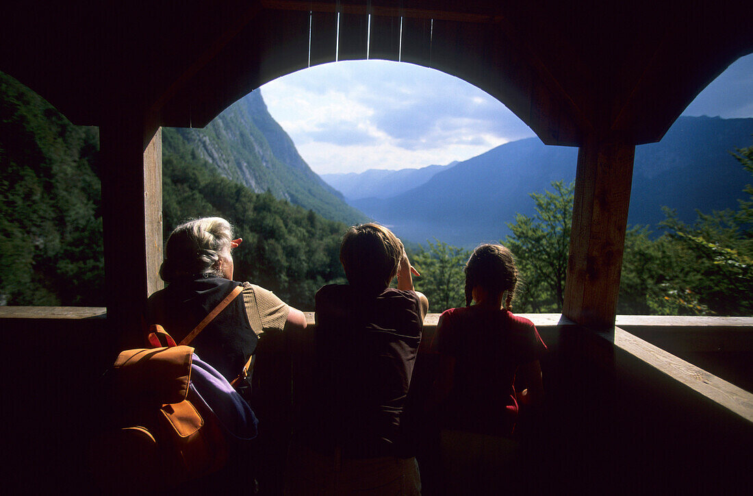 Grandmother with grandchildren admiring the view, View towards Lake Bohinj, Slovenia