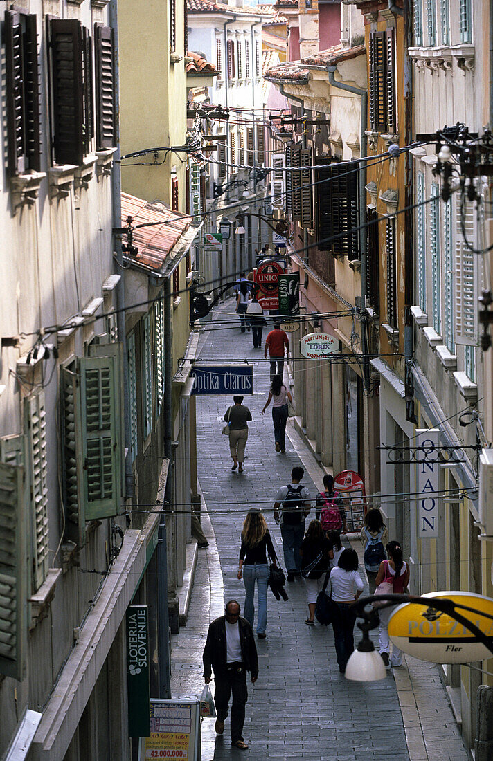 People shopping in an alley in the historic centre of Koper, Slovenia