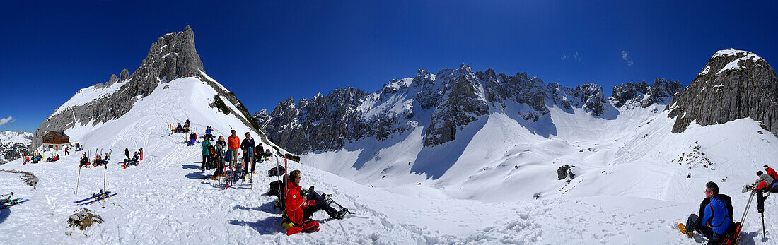 Groups of backcountry skiers resting near Fritz-Pflaum lodge, Griesner Kar, Wilder Kaiser, Kaiser range, Tyrol, Austria