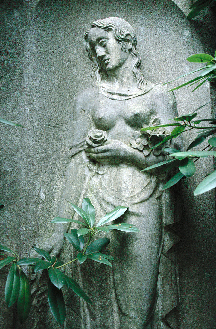 Statue of woman in Ohlsdorf Cemetery park, Hamburg. Germany