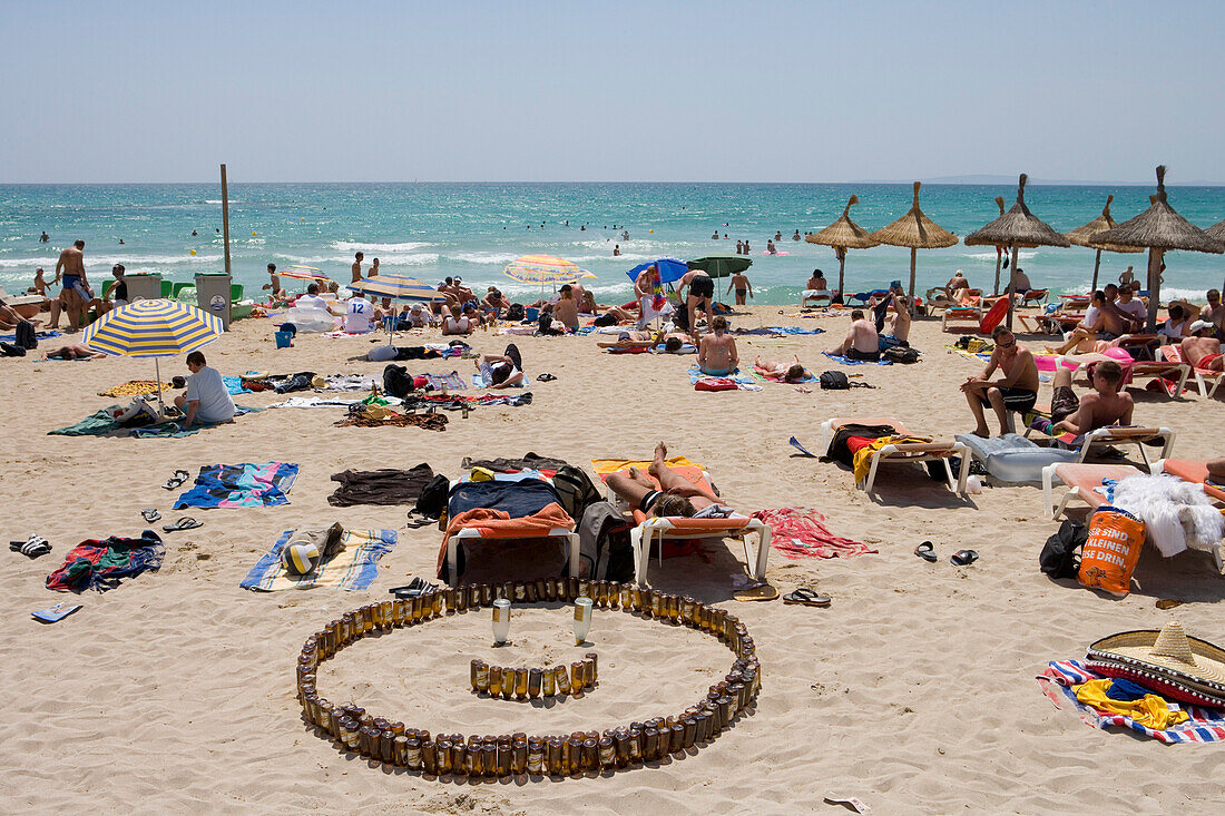 San Miguel Beer Bottle Smile on Beach, El Arenal, Playa de Palma, Mallorca, Balearic Islands, Spain