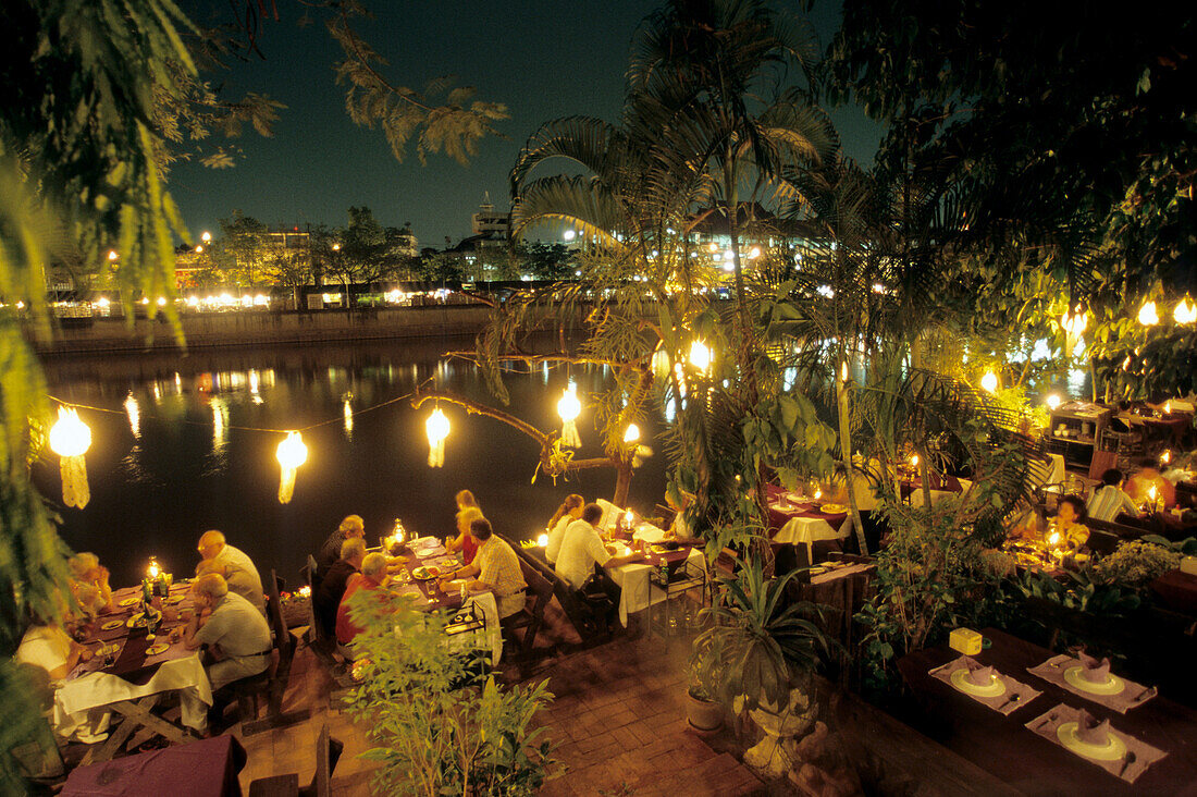 People dining in a restaurant near a river, Chiang Mai, North Thailand, Thailand