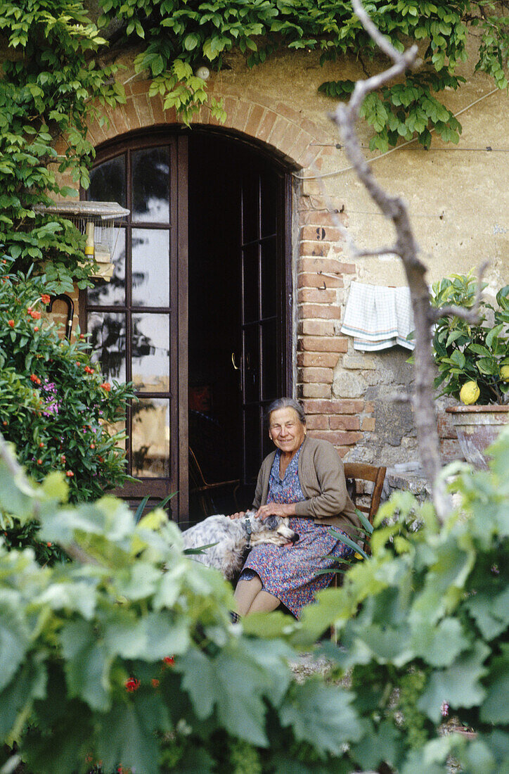 Woman at her courtyard. San Gimignano. Tuscany. Italy