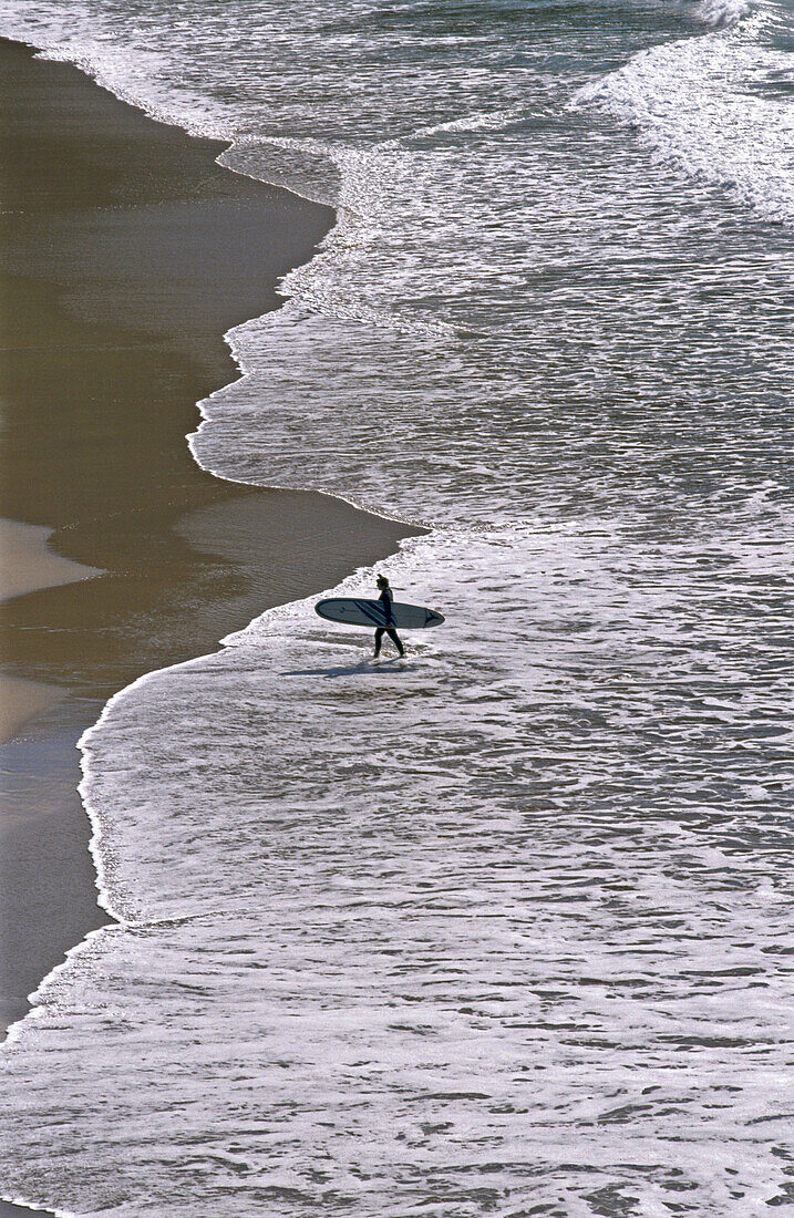 Surfer at Slea Head cape, Dingle peninsula. Co. Kerry, Ireland