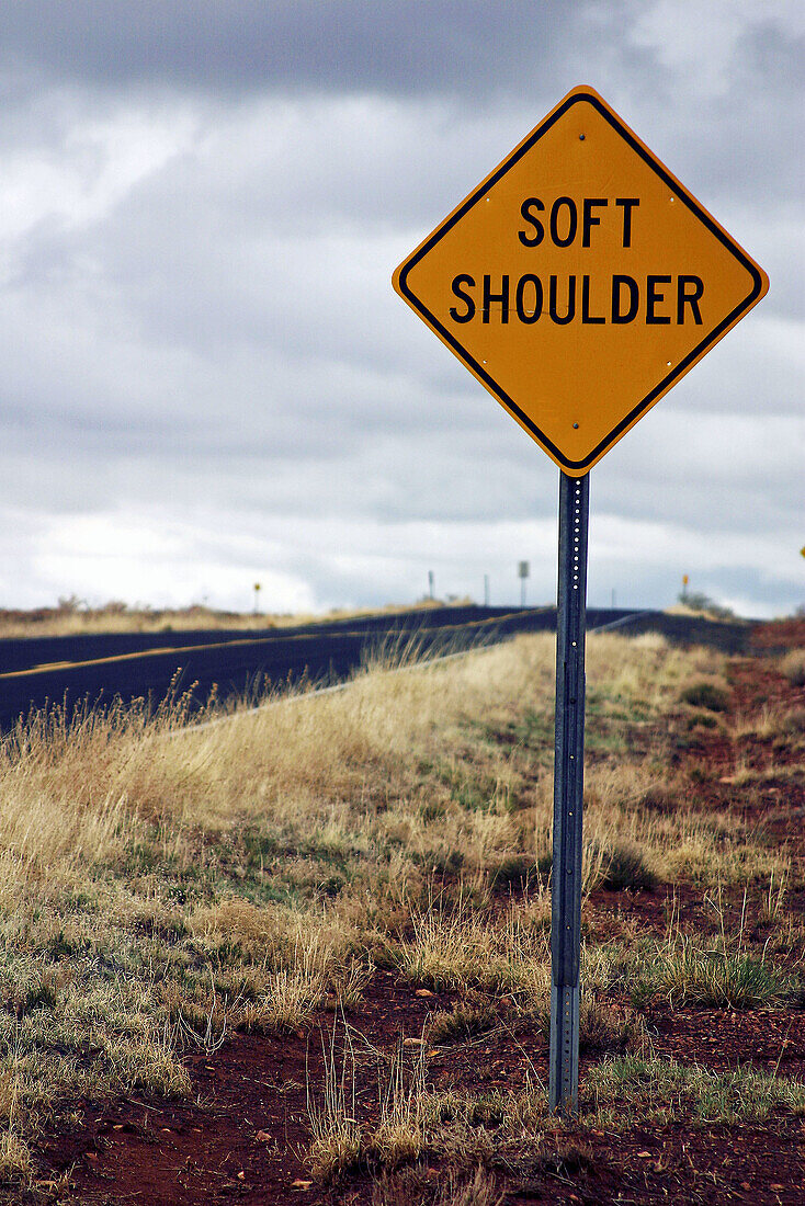 Soft shoulder sign on side of road in the desert