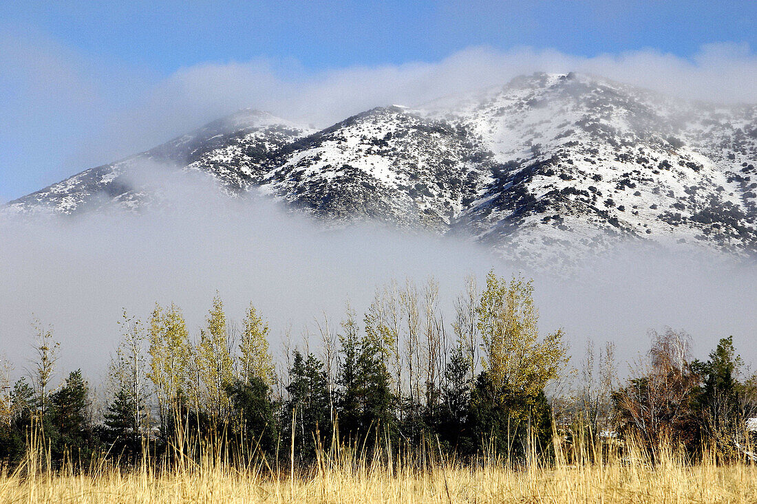 Sunny, wintery day in the mountains with a low cloud layer