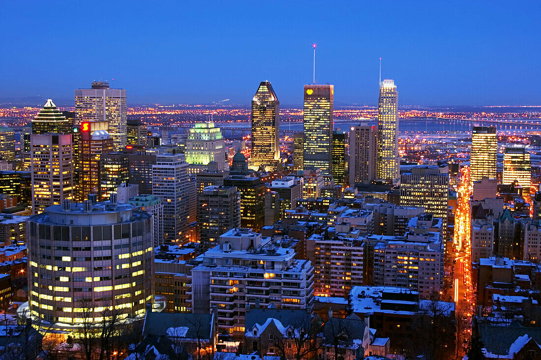 Nighttime view of downtown Montreal skyline and South Shore from atop Mount Royal (Mont Royal) in winter. Quebec, Canada