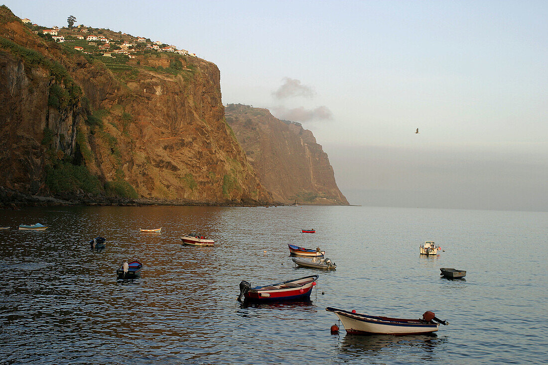 Fishing boats and cliffs. Pedra de Nossa Senhora. Ribeira Brava. Madeira. Portugal