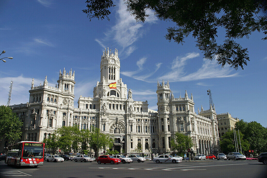 Architecture, Building, Buildings, Cities, City, Cityscape, Cityscapes, Color, Colour, Daytime, Edificio de Correos, Europe, Exterior, Flag, Flags, La Cibeles, Madrid, Outdoor, Outdoors, Outside, Palacio de Comunicaciones, Spain, Square, Squares, Traffic,