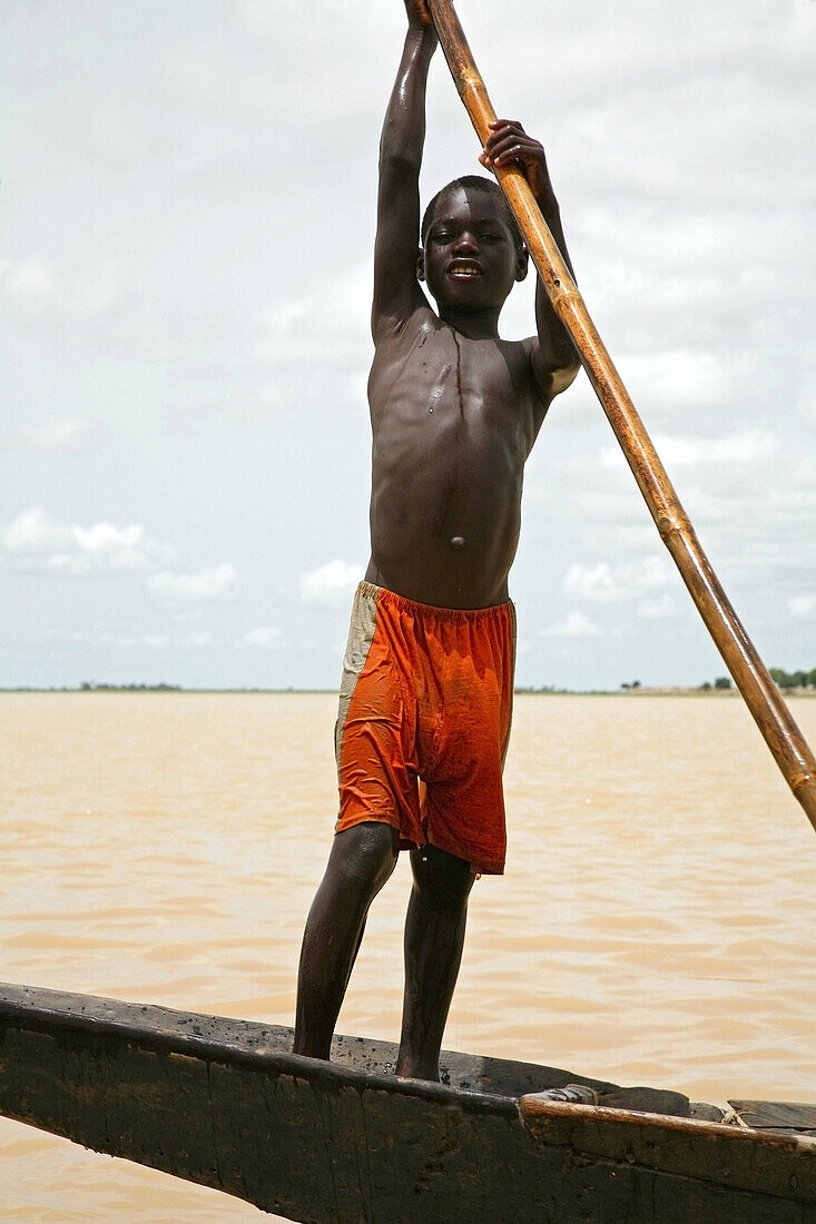 Bozo boy in a fishermens canoe, Bani River near Mopti. Mali