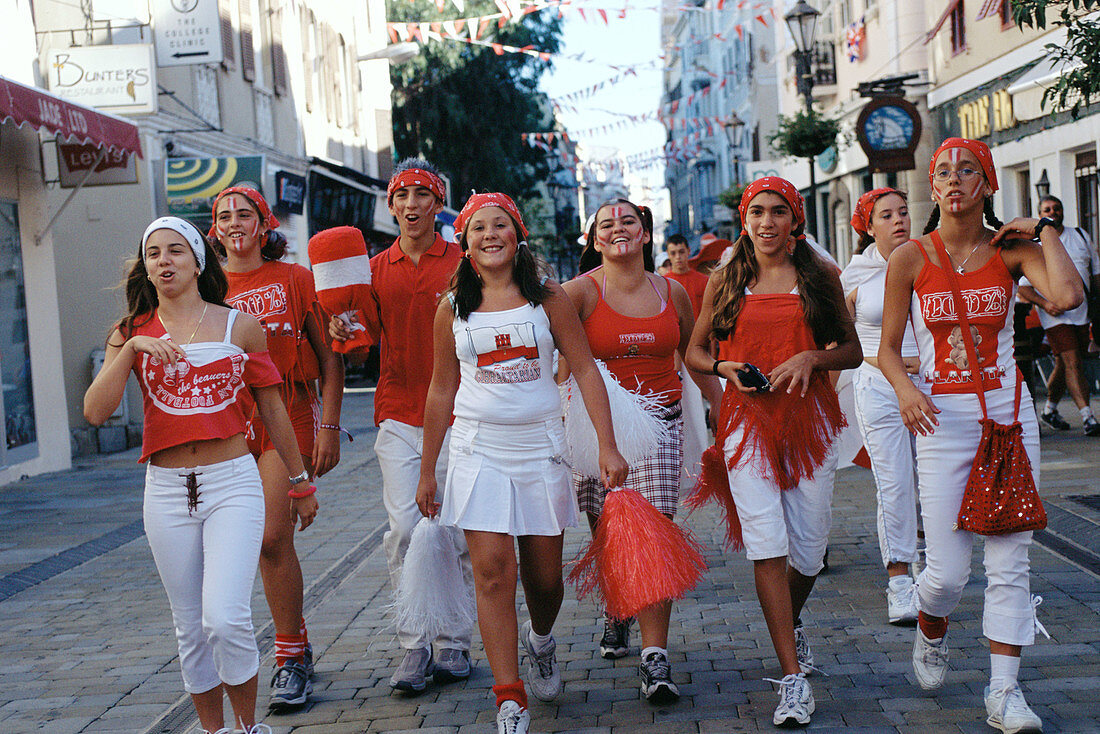 Youngsters dressed up with Gibraltars flag colors celebrating National day (September the 10th). Gibraltar. UK