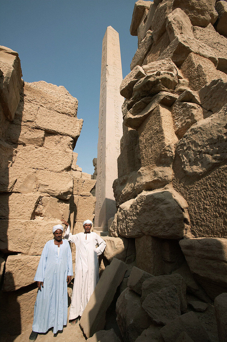 Caretakers pose for a photo near the obelisk at Karnak. Luxor. Egypt