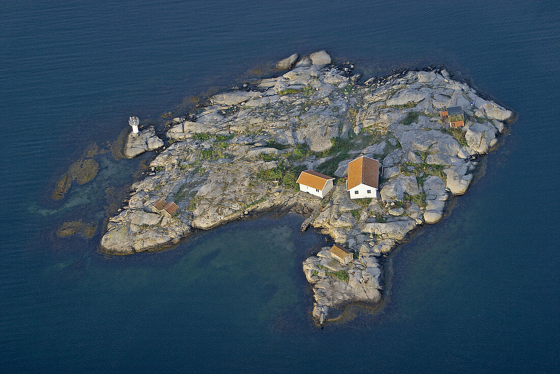 Island in sea, lighthouse and small houses. Hunnebostrand. Bohuslän. Sweden