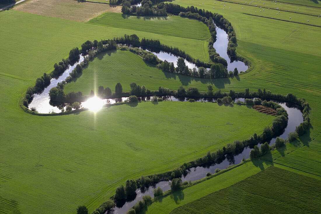 Small river in landscape, sun reflextions. Skellefteå. Västerbotten. Sweden