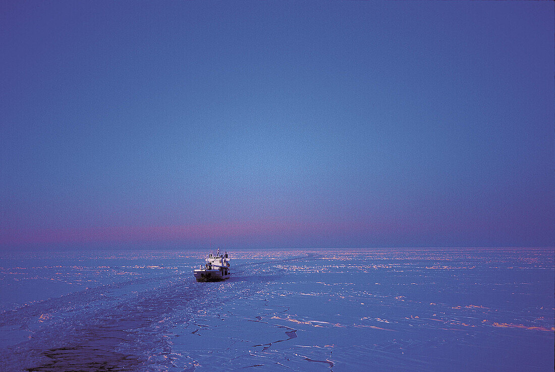 Shipping cargo ship, ice, sea, night, blue, cold. Sweden