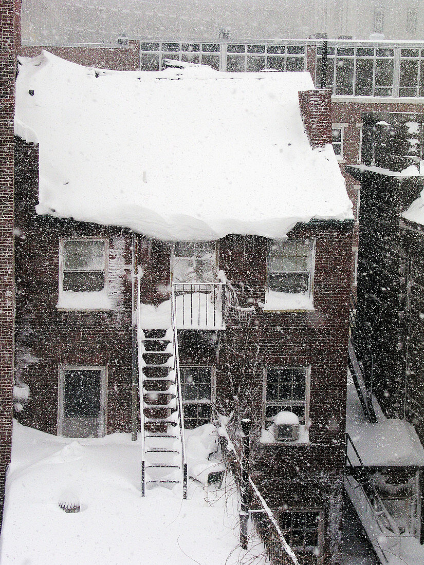 Boston, MA: Snow piles up on a house in Beacon Hill .