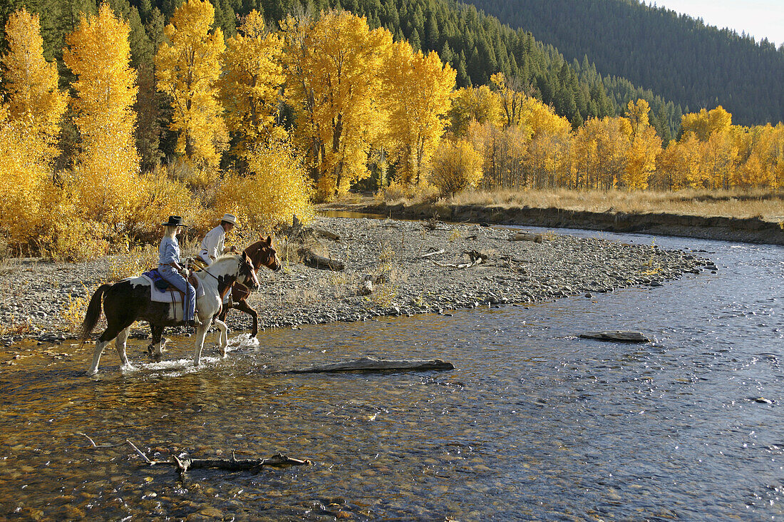 Couple horseback riding near Sun Valley, Idaho. USA