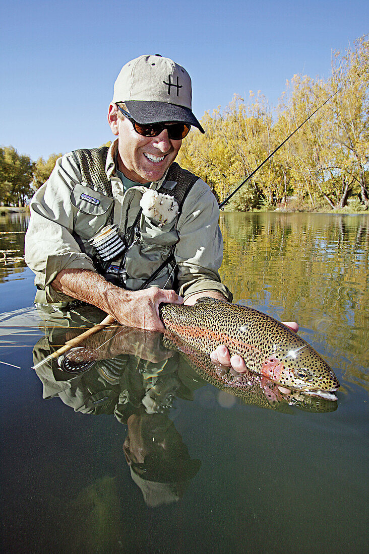 Man holding a rainbow trout. Silver Creek, Idaho. USA