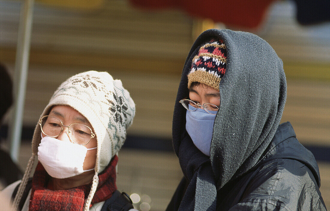 Korean women wearing an anti-pollution mask. Seoul, South Korea