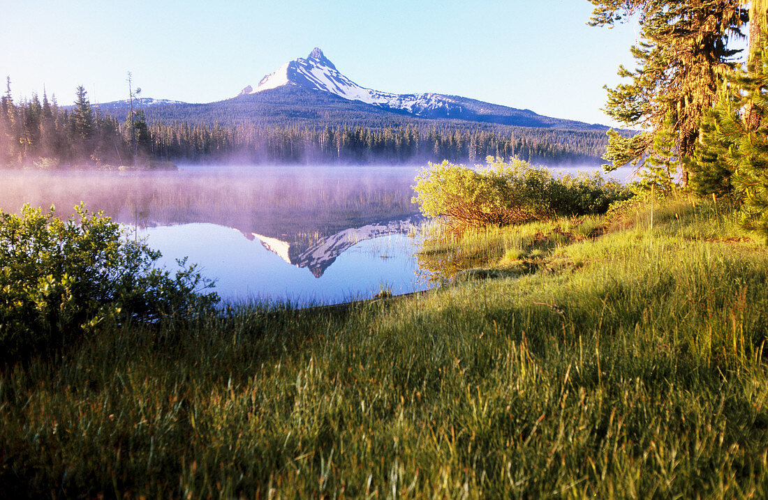 Sunrise through fog, Big Lake. Mount Washington. Oregon. USA.