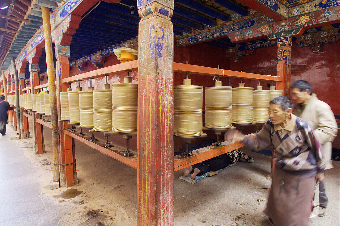buddhist pilgrims action pray wheels suring the sacred kora in the ramoche temple. lhasa. lhasa prefecture. tibet. china. asia.