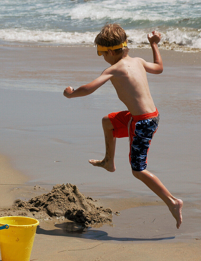 Seven years old child jumping. Dana Point, California. USA.