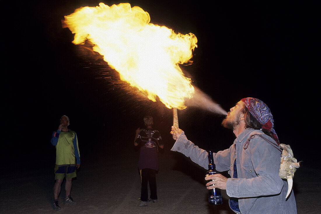 Fire eater at Burning Man Festival. Nevada, USA