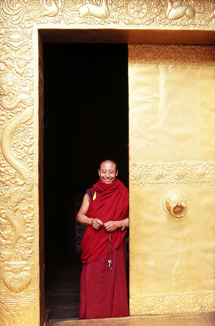 Monk in doorway at the Punakha Dzong, Punakha Valley, Bhutan