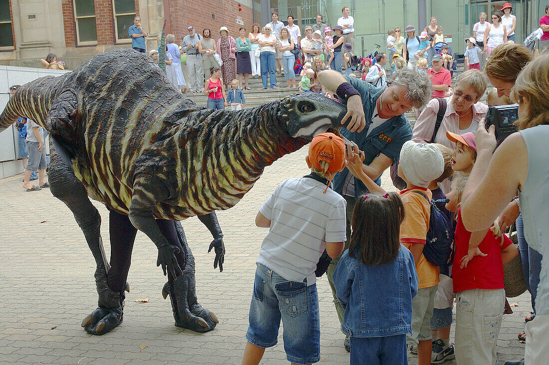 Children meet life-sized mobile dinosaur puppets at the Western Australian Museum, a street performance as part of the Perth Festival 2006.
