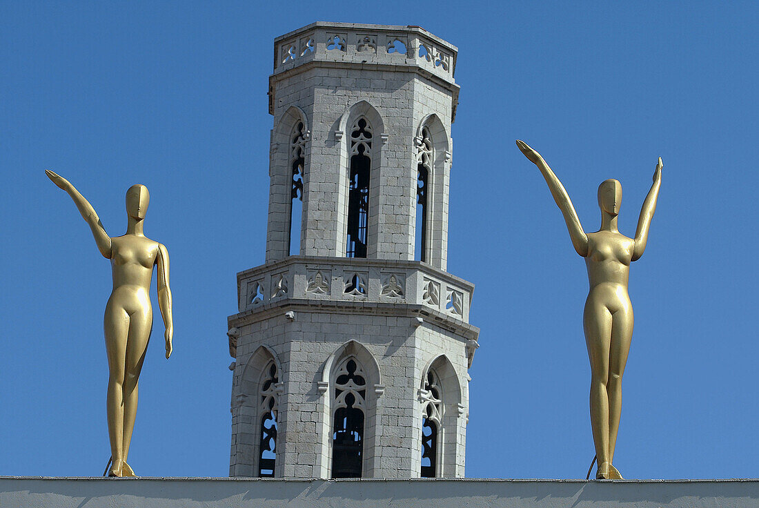 Statues in the exterior of Dalí Museum in Figueres with St. Peters church tower in background. Alt Empordà, Girona province. Catalonia, Spain