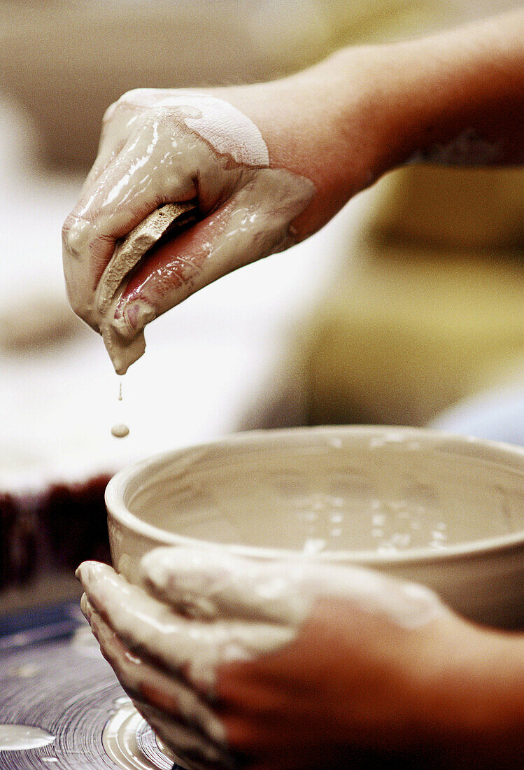 Potter throwing a clay bowl