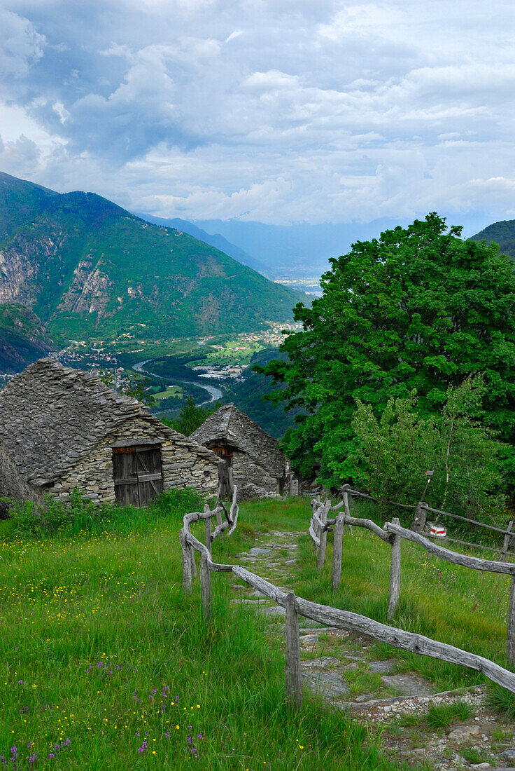 Alpine huts of alp Selna with view to Locarno, lake Lago Maggiore, Ticino, Switzerland