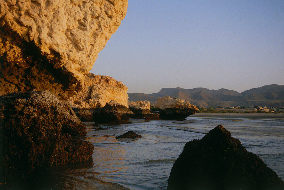 Rocky coast at dusk, Maskat, Oman, Asia