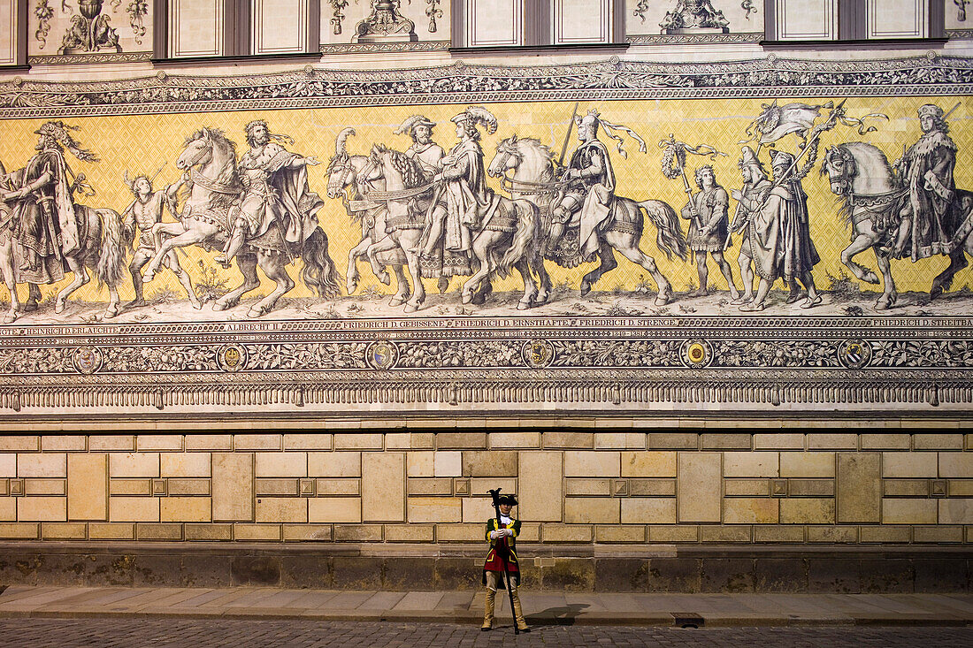 Soldier in front of the Fuerstenzug, depicting a cavalcade and made of 25.000 Meissen porcelain tiles, Dresden, Saxony, Germany, Europe