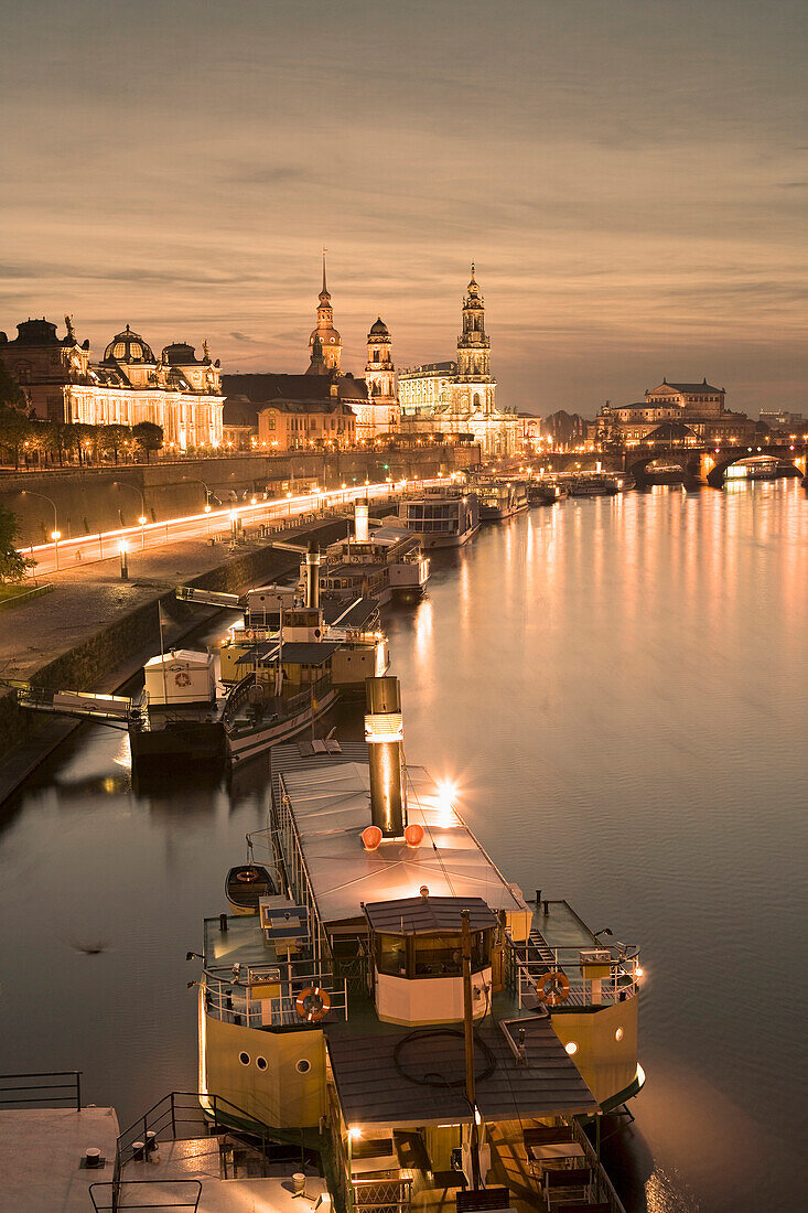 View along river Elber with Bruhl's Terrace, Dresden Castle, Standehaus, Hofkirche and Semperoper at night, Dresden, Saxony, Germany