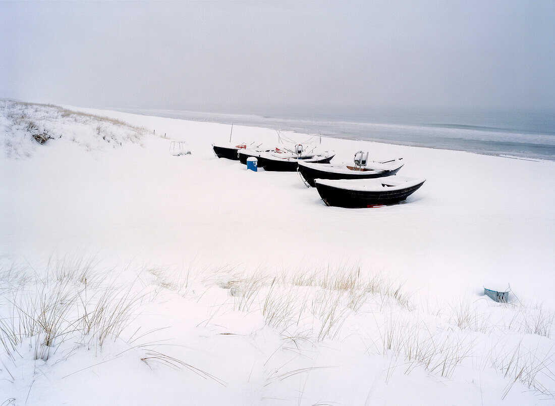 Snow covered boats at beach, Baabe, Rugen island, Mecklenburg-Western Pomerania, Germany