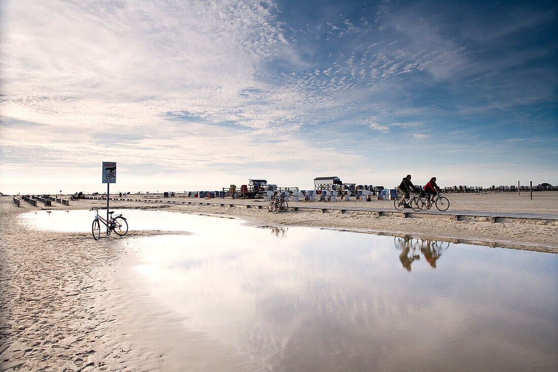 Cyclists at beach, St. Peter-Ording, Schleswig-Holstein, Germany