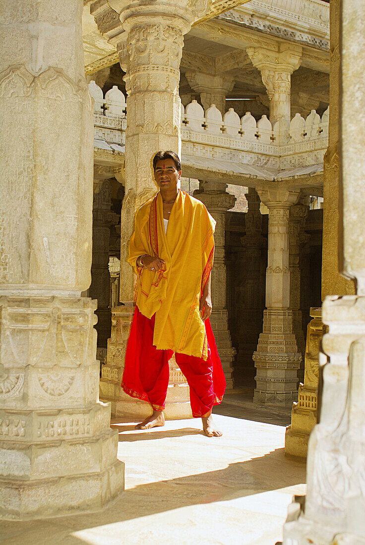Man standing amongst the carved columns in the marble Jain Temple, Ranakpur, Rajasthan, India