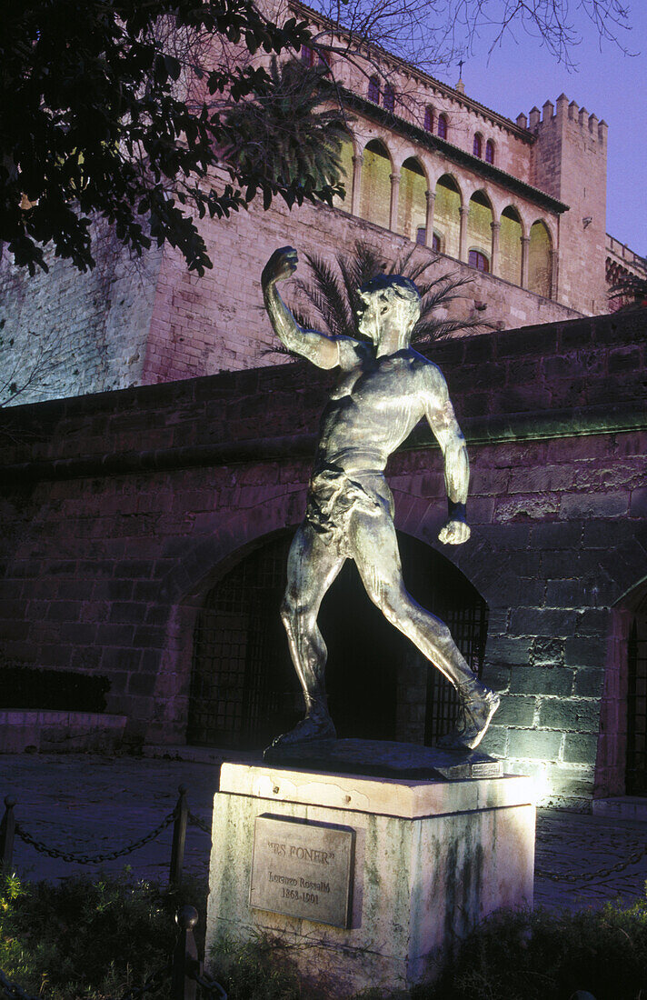 Statue and Almudaina Palace at night, Palma de Mallorca. Majorca, Balearic Islands. Spain