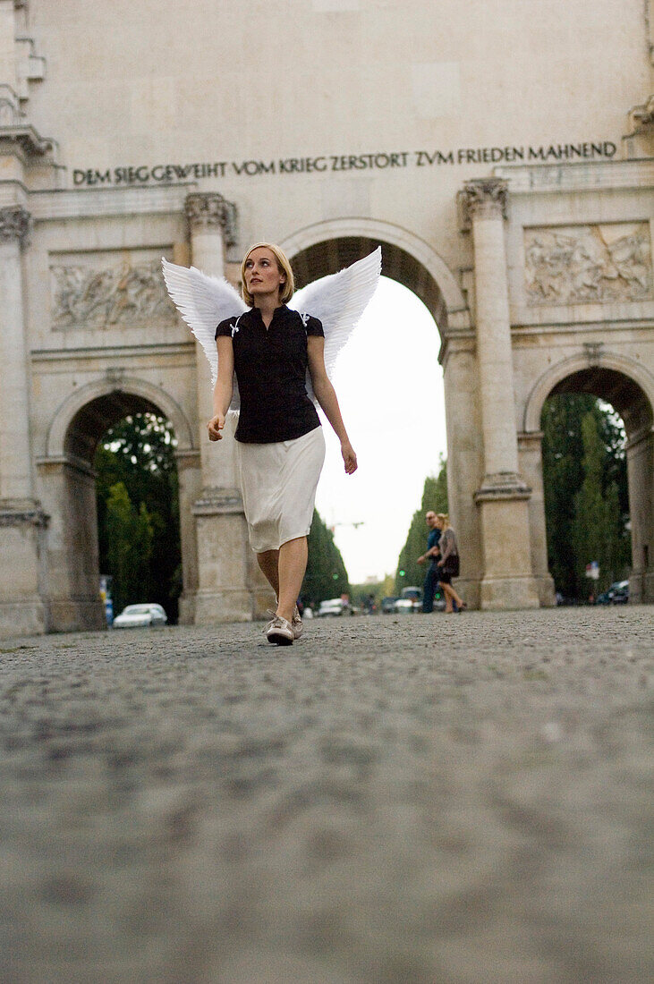 Angel, young woman with wings at the victory gate, Siegestor in Munich, Bavaria, Germany