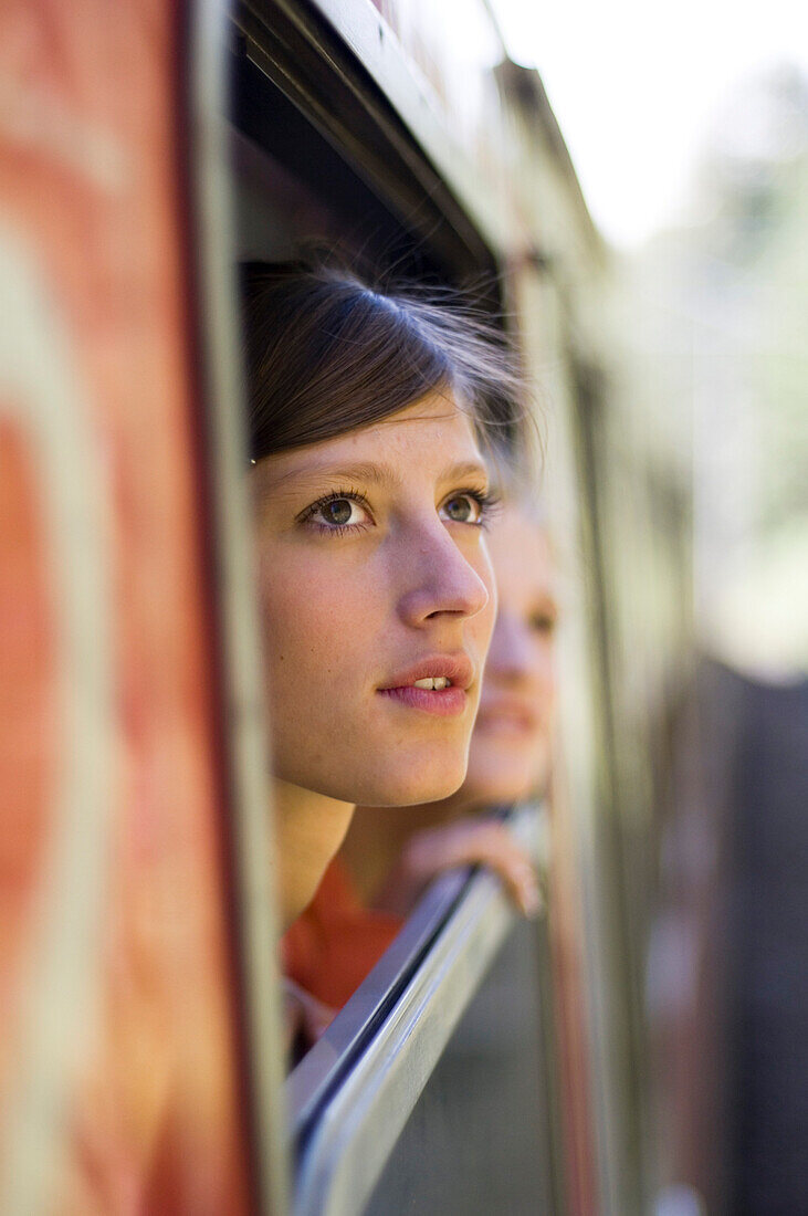 Young woman, girl looking out of a train, Travel, Mittenwald, Upper Bavaria, Bavaria, Germany