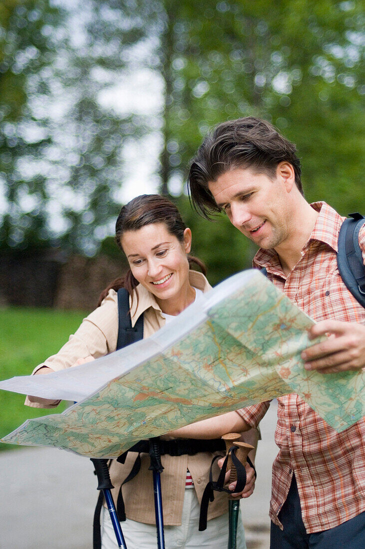 Couple reading a map, Garmisch Partenkirchen, Bavaria, Germany