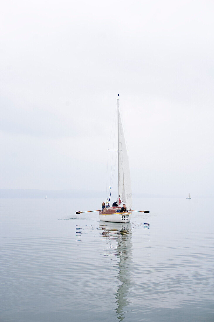 Family in a sailing boat on Lake Ammersee, bavaria, Germany
